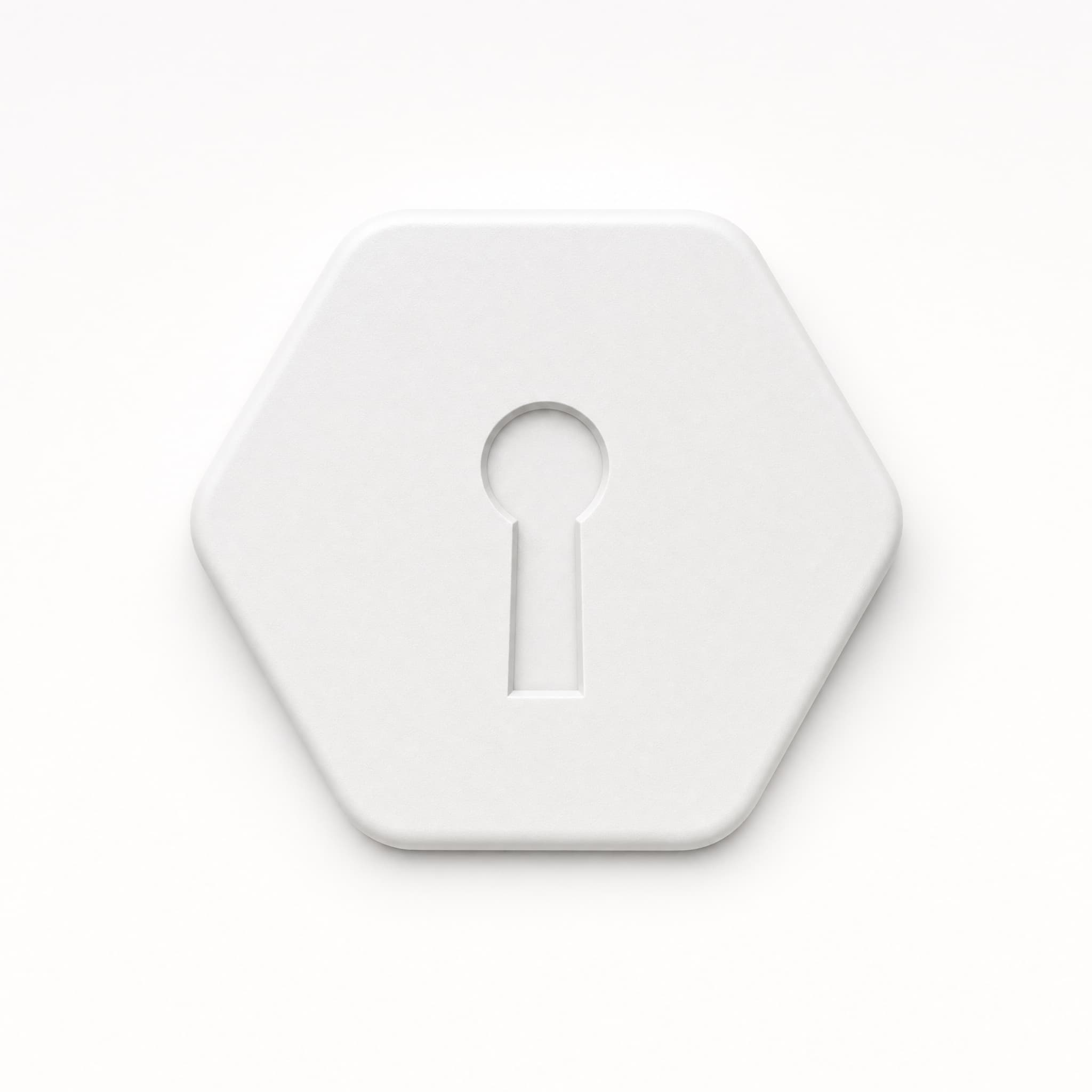 The Key — a white hexagonal token — being tapped against an iPhone on a wooden desk